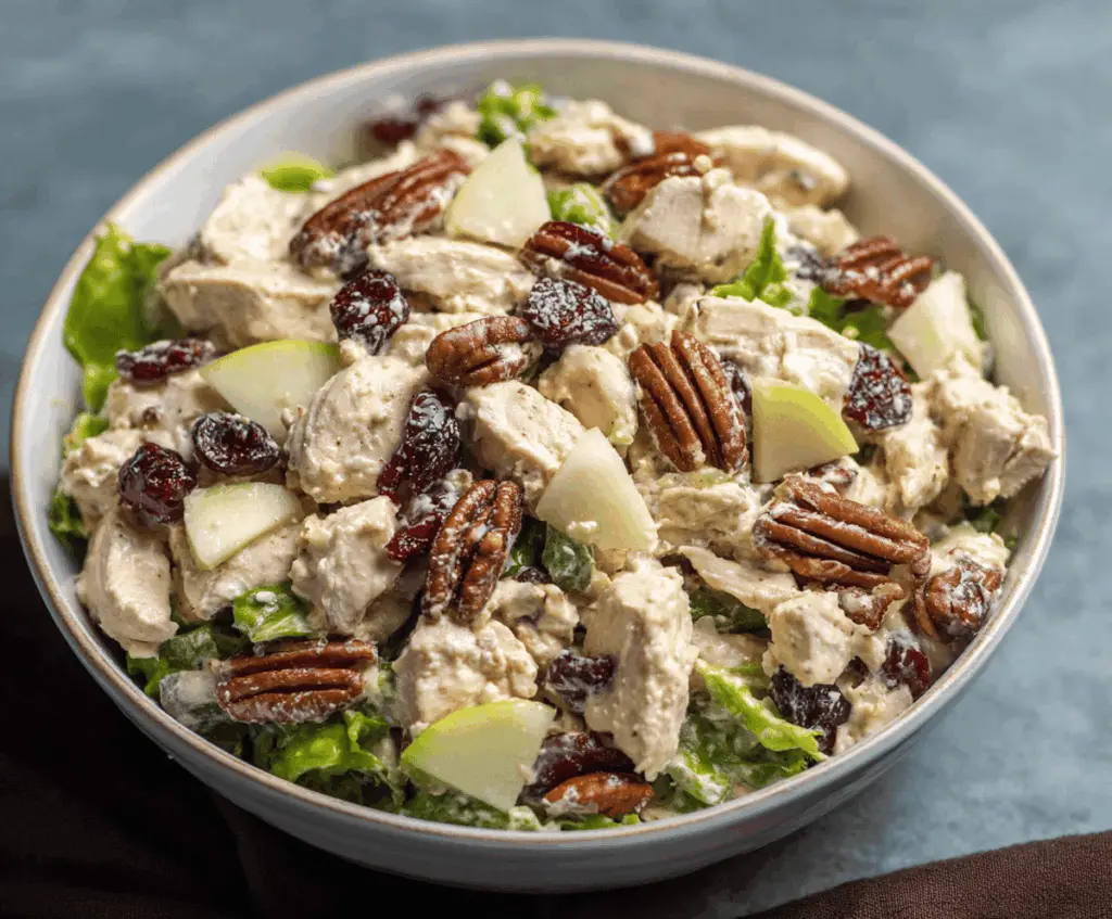 Creamy apple pecan chicken salad with fresh greens, sliced apples, toasted pecans, and tender chicken served in a bowl