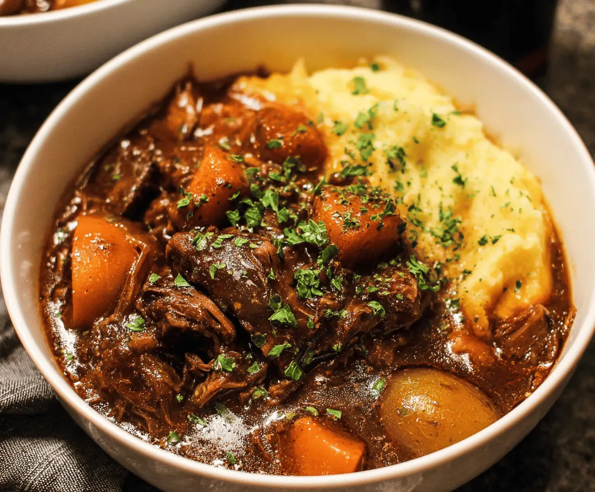 Hearty Beef and Guinness Stew with tender beef chunks, vegetables, and rich gravy served in a rustic bowl.