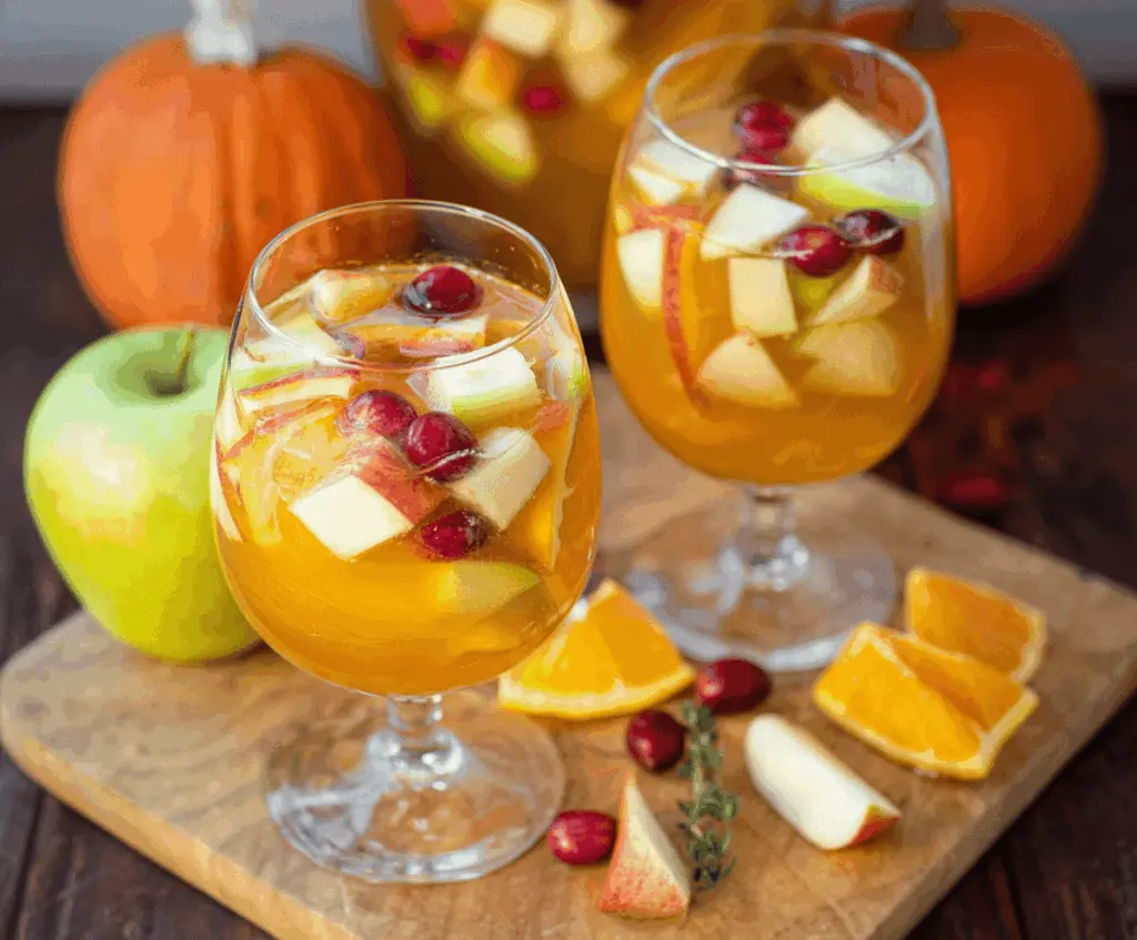 Refreshing Pumpkin Spice Sangria with Citrus slices and apple chunks in a glass pitcher, perfect for fall celebrations