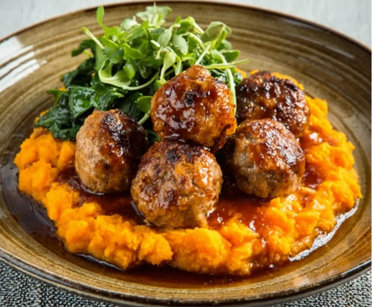 Delicious pork meatballs served with creamy sweet potato mash, perfect for a comforting meal.
