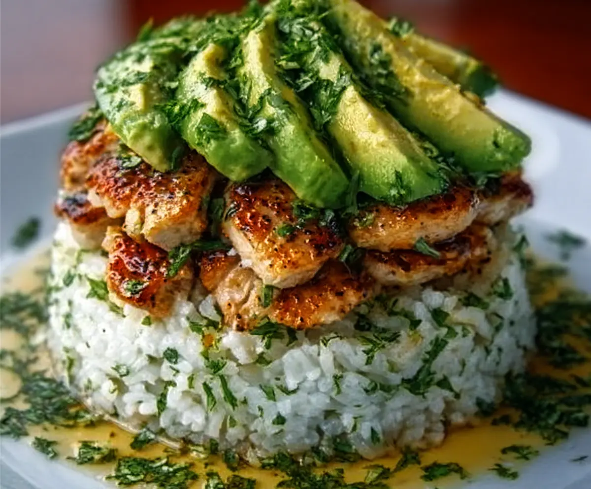 Honey Lime Chicken & Avocado Rice Stack served on a white plate with fresh ingredients