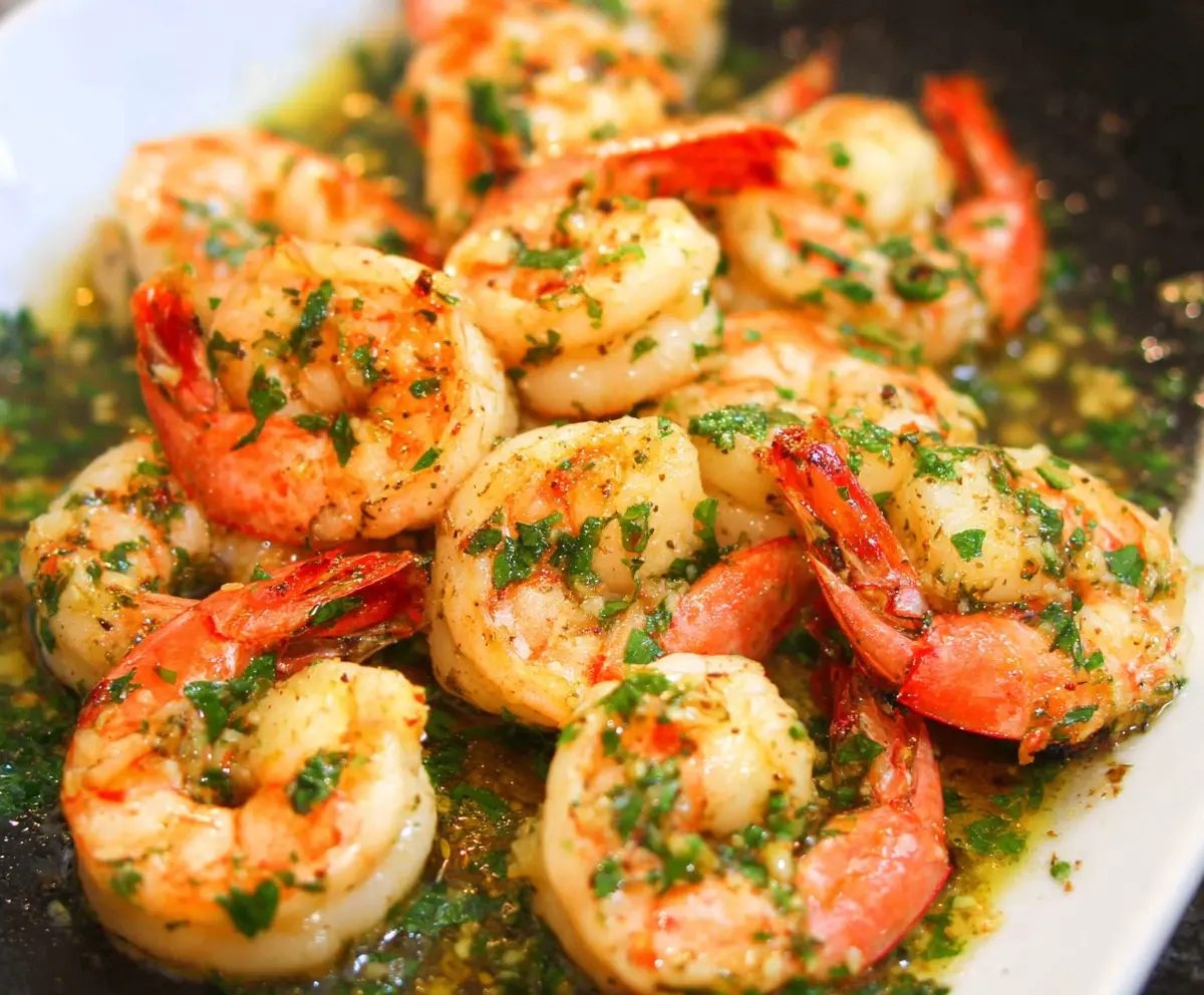 Delicious shrimp scampi with garlic butter served on a plate, garnished with fresh herbs.