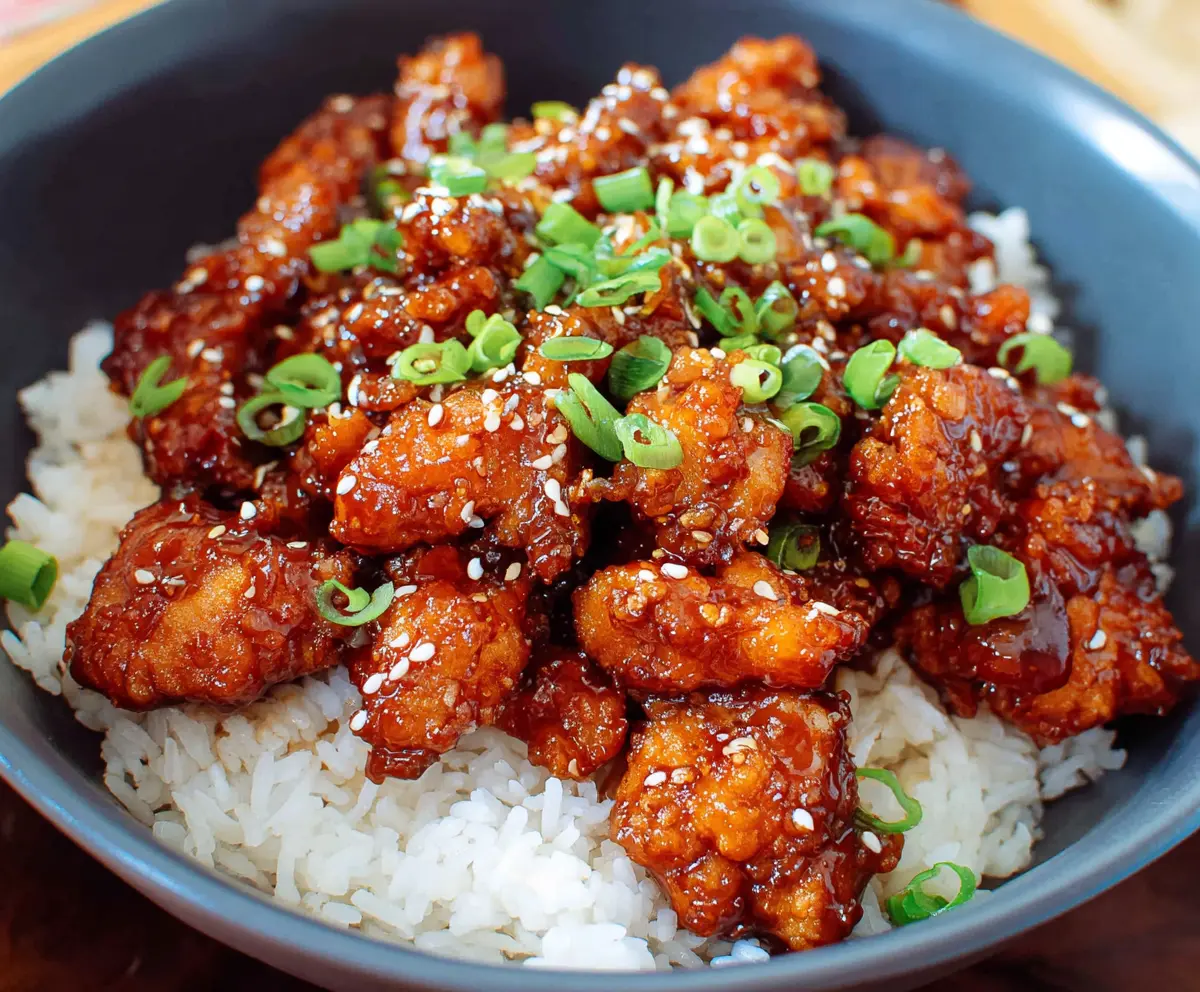 Delicious crispy General Tso’s Chicken served with steamed rice and sliced green onions