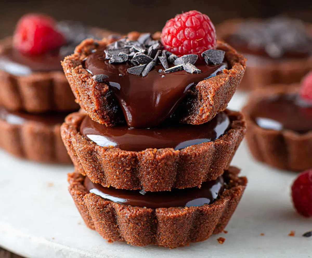 Delicious mini chocolate tarts topped with smooth ganache for a rich dessert.