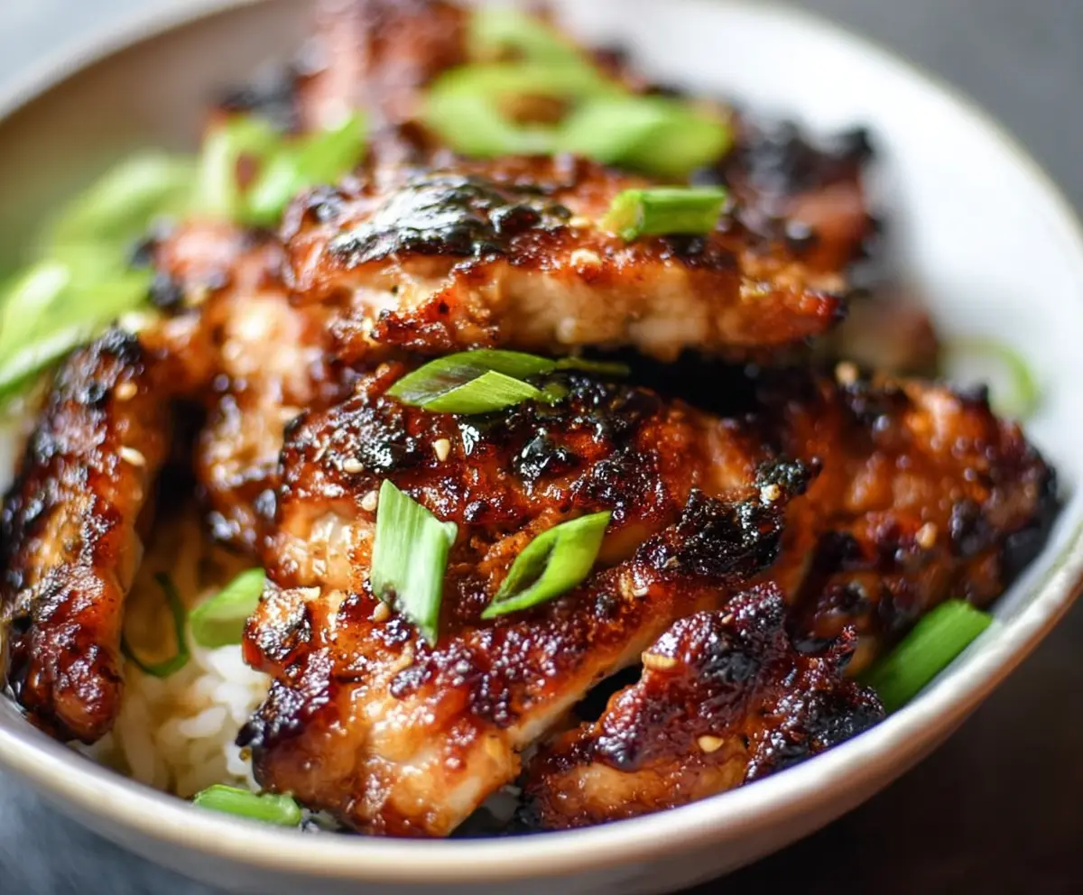Delicious air fryer Asian-glazed boneless chicken thighs served on a plate with dipping sauce
