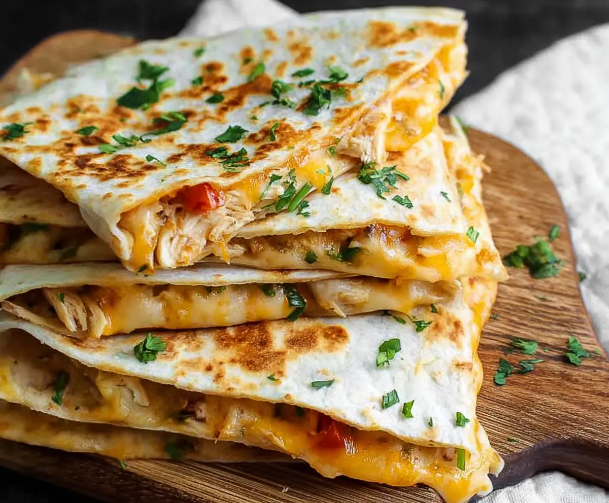 Delicious cheesy chicken quesadillas with melted cheese and grilled tortillas, perfect for a quick snack or meal.