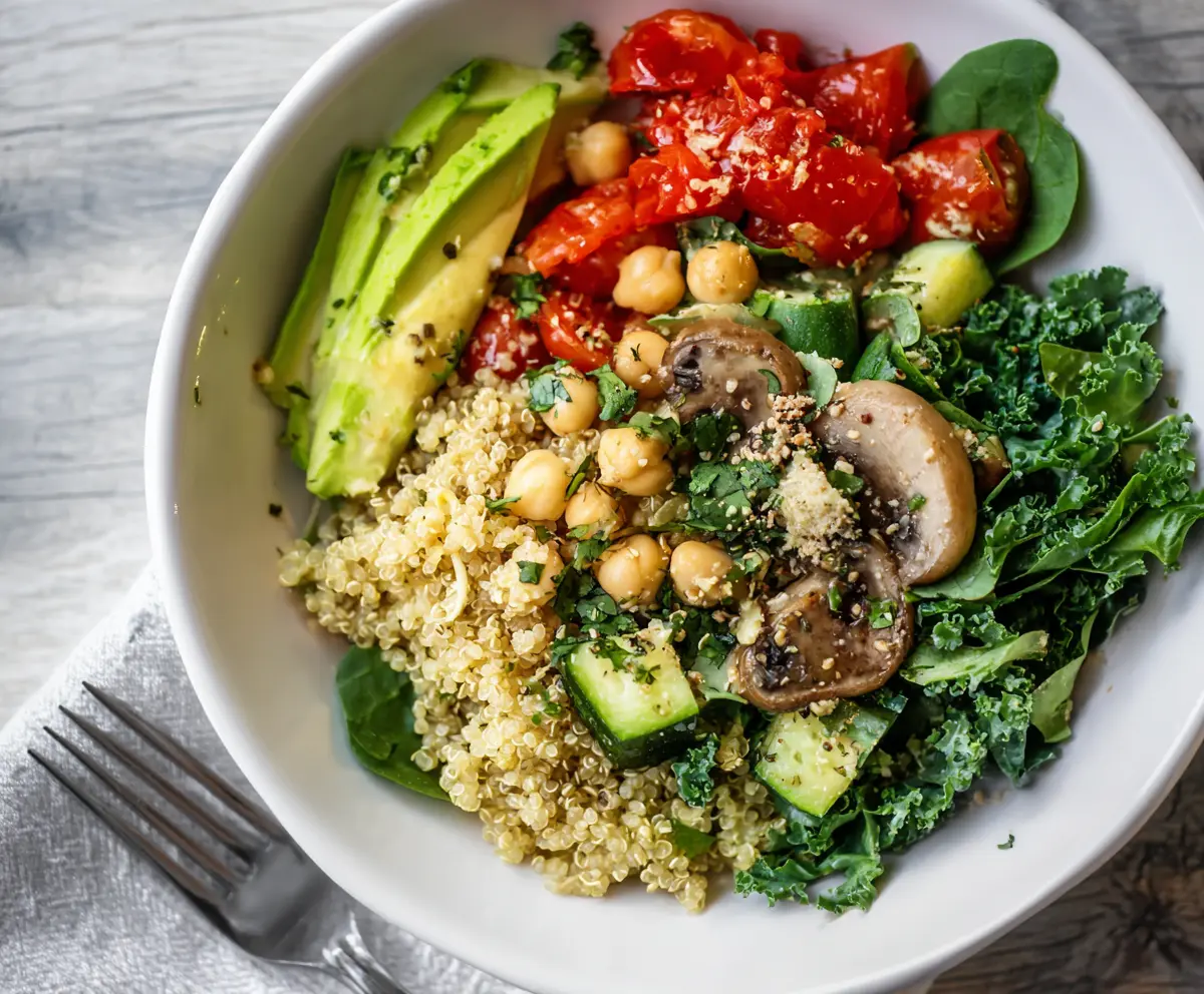 Healthy clean eating quinoa veggie bowl filled with colorful fresh vegetables and fluffy quinoa.