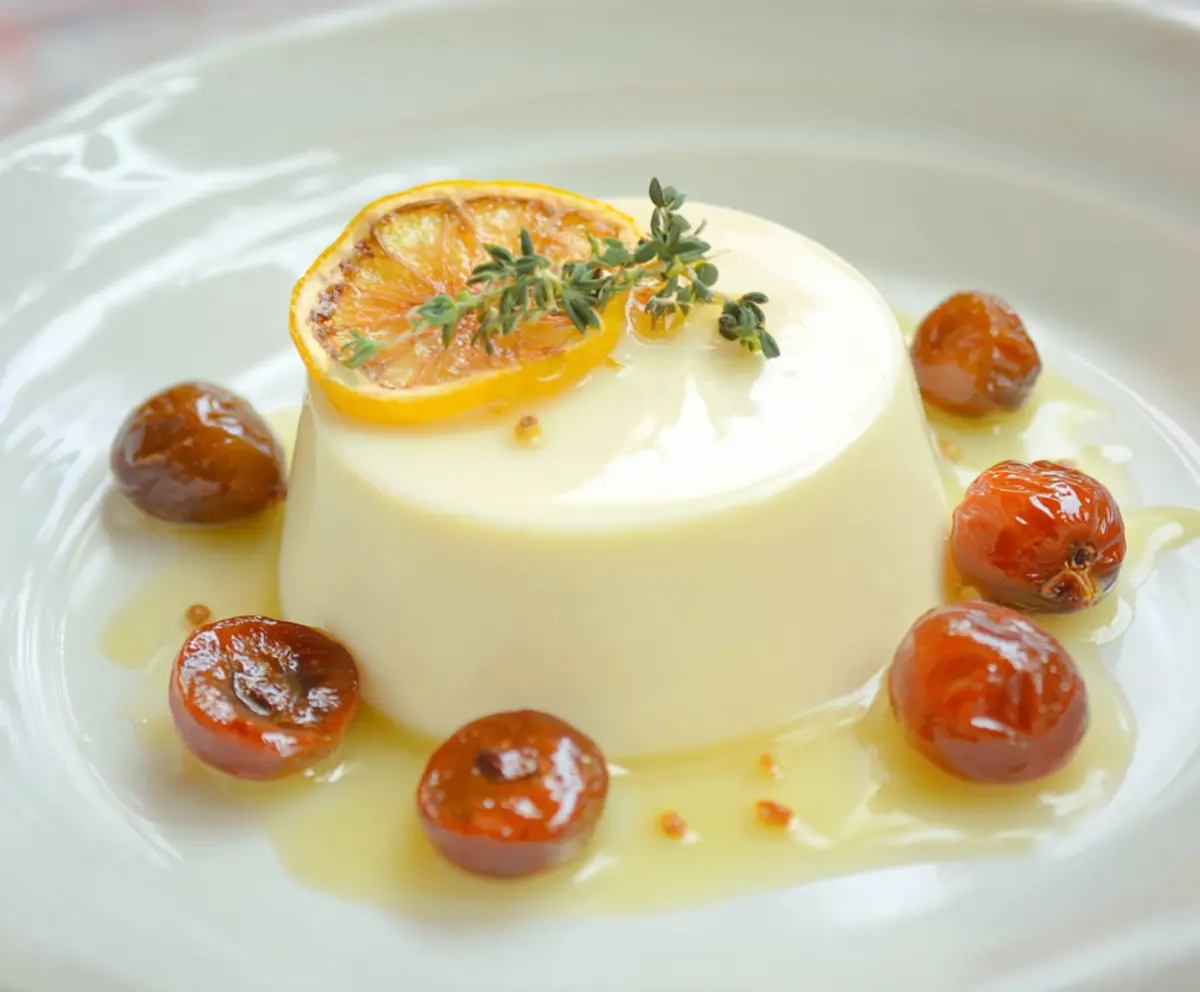 Creamy Lemon Panna Cotta in a glass, garnished with fresh lemon slices and mint leaves.