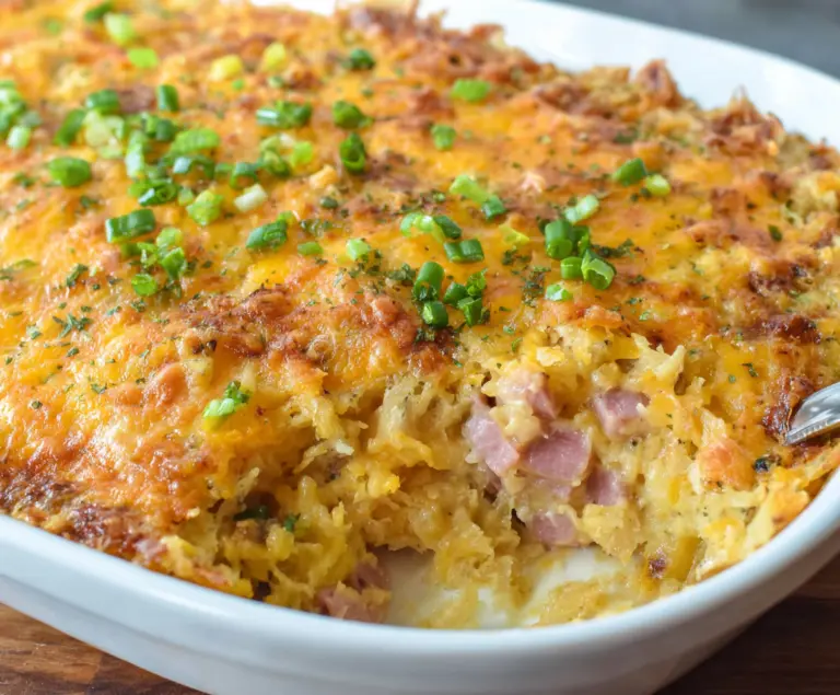 Delicious Cheesy Ham Hashbrown Casserole served hot with melted cheese and crispy hashbrowns.