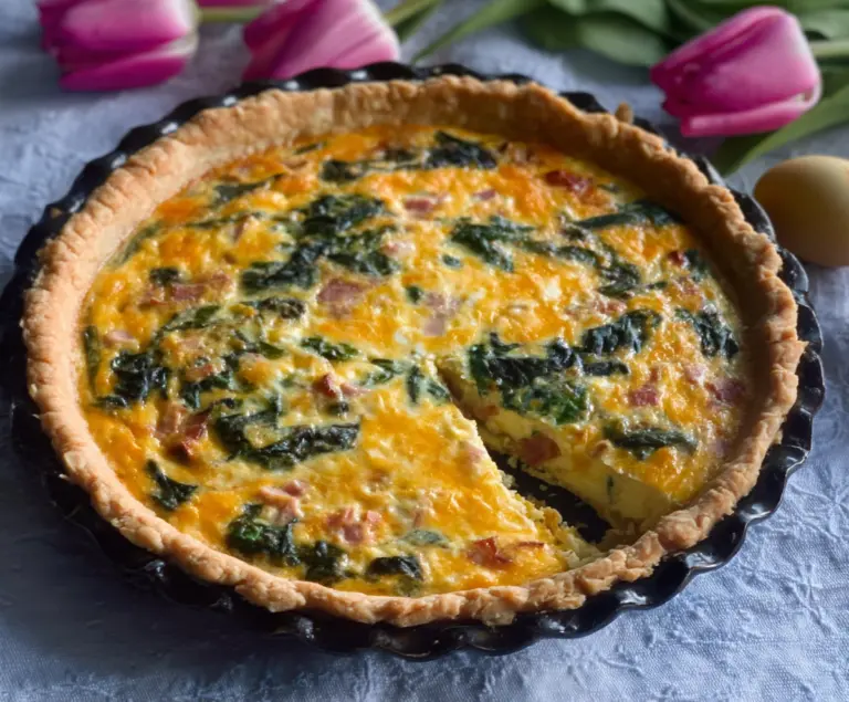 Delicious Easter ham and spinach quiche, served fresh with a golden crust.